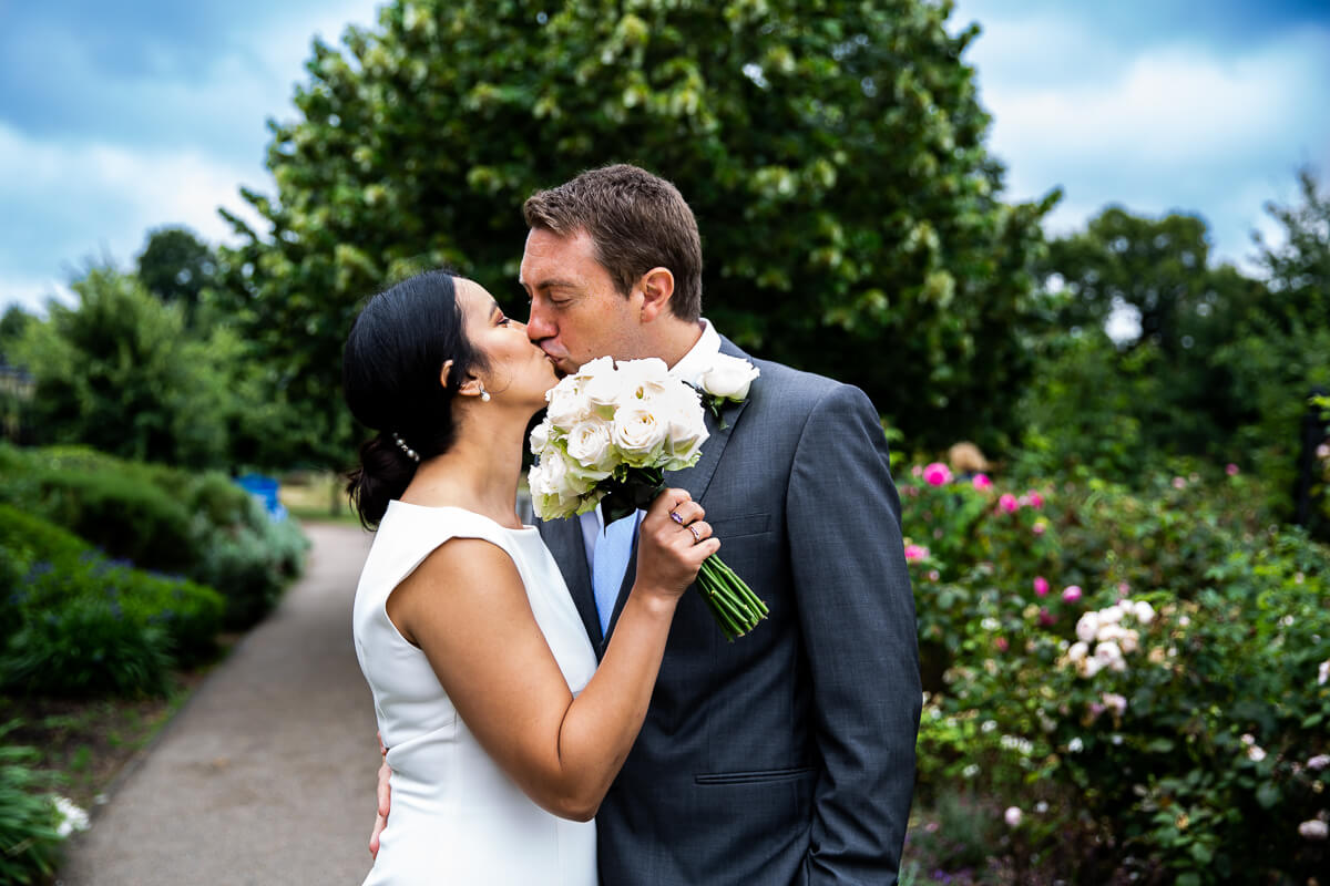 Concealed wedding kiss in the gardens